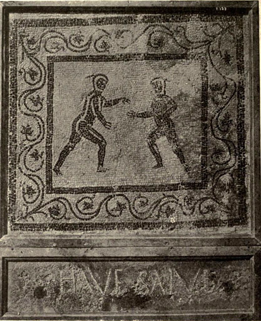 Boscoreale. Villa of Numerius Popidius Florus. Frigidarium 7. Emblema mosaic with two nude wrestlers and the threshold greeting HAVE SALVE.
See Notizie degli Scavi di Antichità, 1921, p.450, fig. 15.

