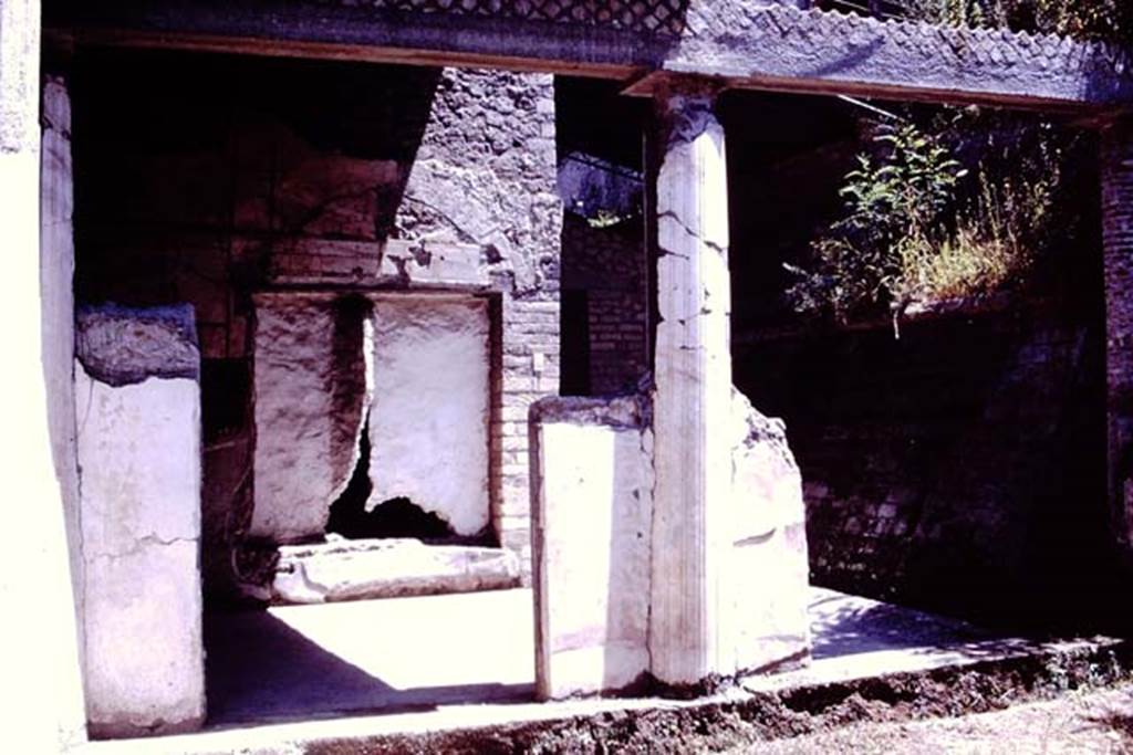 Oplontis, 1977. Portico 13, looking east from peristyle 19, onto portico 13 and towards imprint of window of room 11, which was ajar at the time of the eruption. 
Photo by Stanley A. Jashemski.   
Source: The Wilhelmina and Stanley A. Jashemski archive in the University of Maryland Library, Special Collections (See collection page) and made available under the Creative Commons Attribution-Non Commercial License v.4. See Licence and use details. J77f0355
