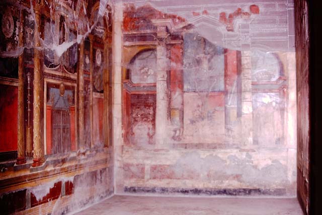 Oplontis Villa of Poppea, 1974. Room 14, triclinium, with painted walls with architectural Helenistic elements, including temples, figured capitals, griffins and stems of ivy with precious gems that adorn the golden columns. Photo by Stanley A. Jashemski.   
Source: The Wilhelmina and Stanley A. Jashemski archive in the University of Maryland Library, Special Collections (See collection page) and made available under the Creative Commons Attribution-Non Commercial License v.4. See Licence and use details. J74f0646
