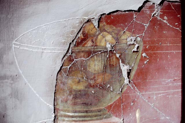 Oplontis, May 2010. Room 23, detail of painted mask in centre of west wall. Photo courtesy of Buzz Ferebee.