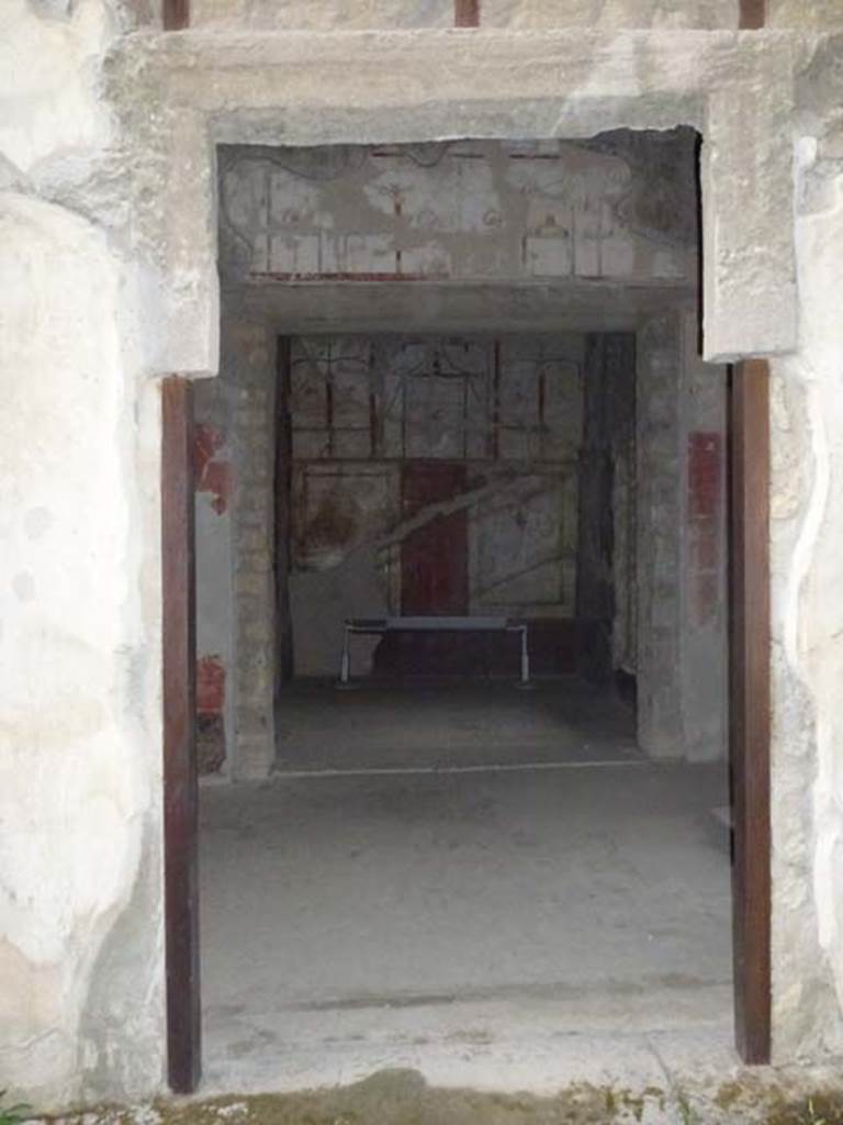 Oplontis, May 2010. Room 41, painted decoration on upper west wall of alcove. 
The small doorway leads into room 38. Photo courtesy of Buzz Ferebee. 
