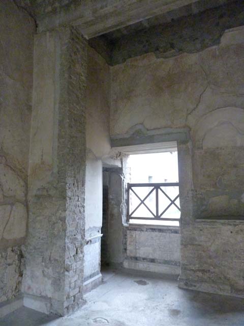 Oplontis, September 2011. Room 64, looking north through doorway from corridor 63, towards the wall zoccolo and base of the niche/recess in room 64. Photo courtesy of Michael Binns.
