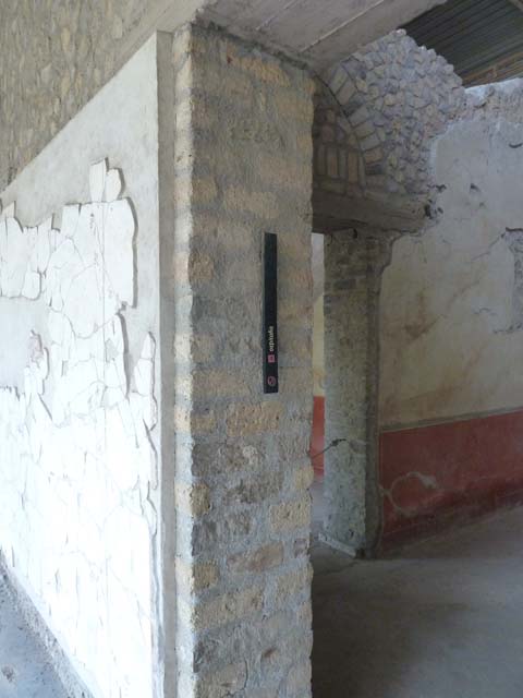 Oplontis, September 2015. Room  90, south pilaster with marker indicating room 90 was one of a group of rooms set aside for guests, indicated by the sign “ospitalia”.