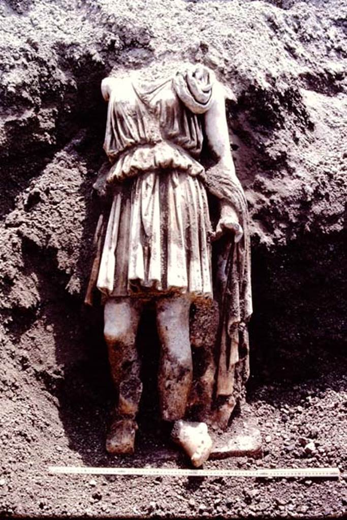 Oplontis Villa of Poppea, July 1983. Headless statue of Artemis/Diana found still standing on the statue base, and reunited with both feet. 
Source: The Wilhelmina and Stanley A. Jashemski archive in the University of Maryland Library, Special Collections (See collection page) and made available under the Creative Commons Attribution-Non Commercial License v.4. See Licence and use details.
Oplo0229
