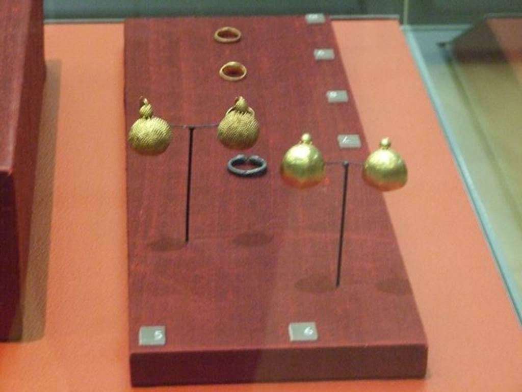 Oplontis, Villa of Lucius Crassius Tertius. Two pairs of gold earrings.
Gold semi spherical  earrings (Right). SAP inventory number 72534-5.
Pair of close embossed spherical segment gold ear rings (left). SAP inventory number 72996 . 
Photographed at “A Day in Pompeii” exhibition at Melbourne Museum. September 2009.
