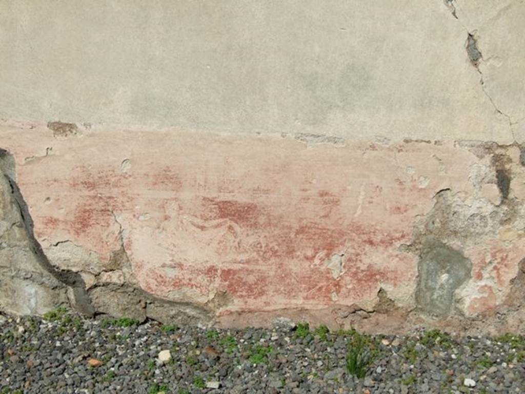 VI.9.2 Pompeii.  March 2009.  Peristyle 16.  North wall.   Detail of painted plaster with remains of figure.