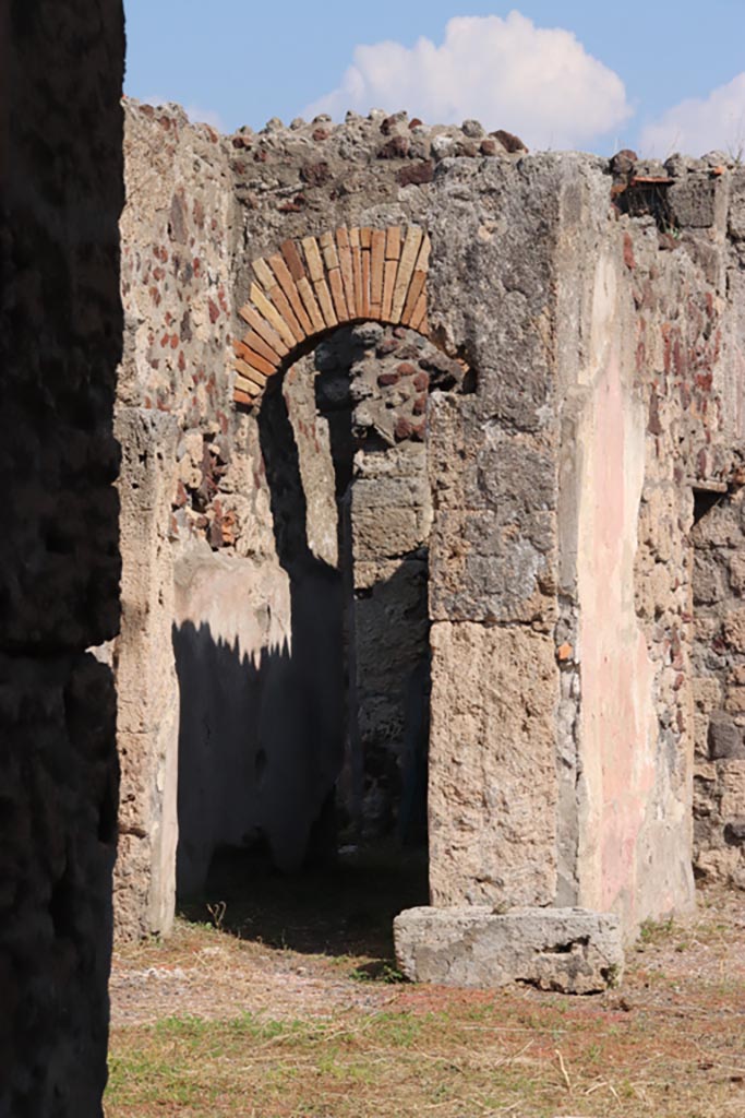 VI.9.2 Pompeii. October 2022. 
Looking east towards pilaster in atrium on north side of tablinum 8, with corridor (32) on left.
Photo courtesy of Klaus Heese.
