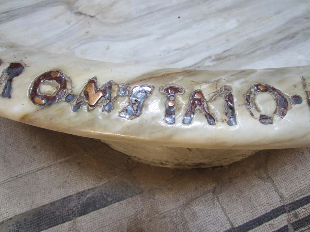 VII.5.24 Pompeii. March 2012. 
Remains of bronze lettering (RO. M. STAIO.) from large marble basin or labrum (41) in apse of caldarium (39). Photo courtesy of Marina Fuxa.
