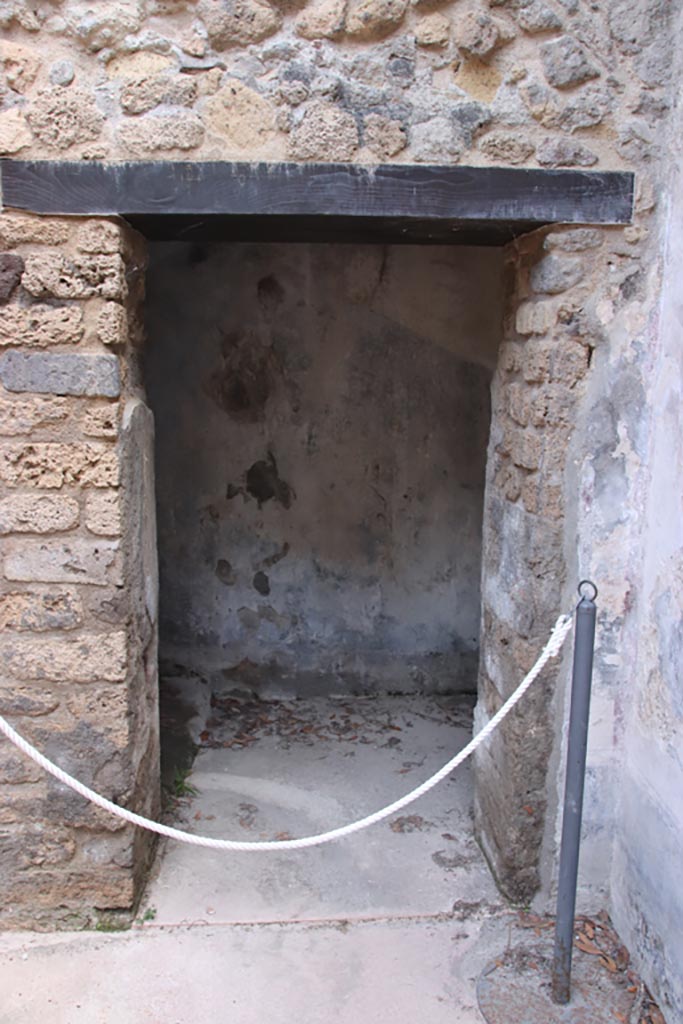 Villa of Diomedes, Pompeii. October 2023. 
Looking east into doorway to steps to upper floor, at east end of room 5,a. Photo courtesy of Klaus Heese.

