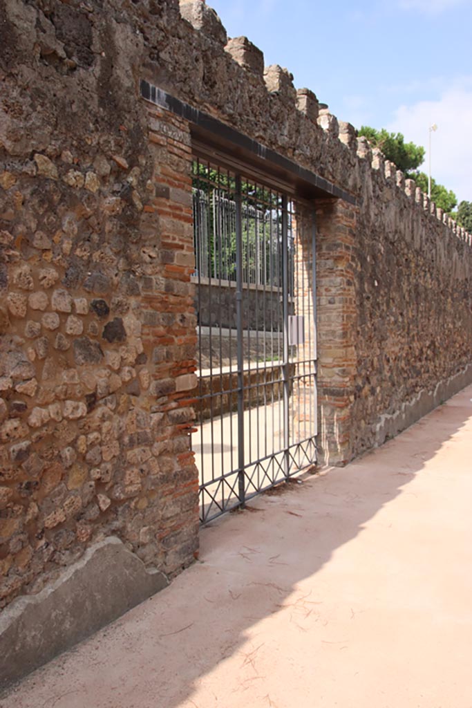 Villa of Diomedes, Pompeii. October 2023. 
Looking towards doorway/gate in exterior west wall of west portico. Photo courtesy of Klaus Heese.
