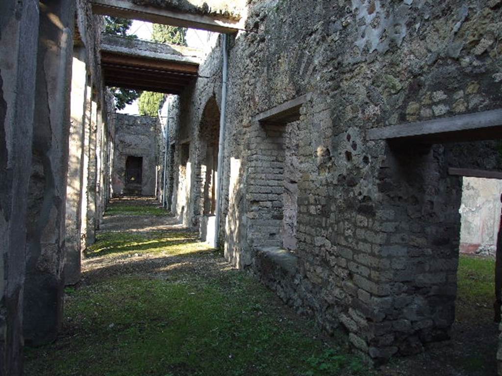 HGW24 Pompeii. December 2006. Looking north along the east portico, the doorway on the right leads to the corridor. 