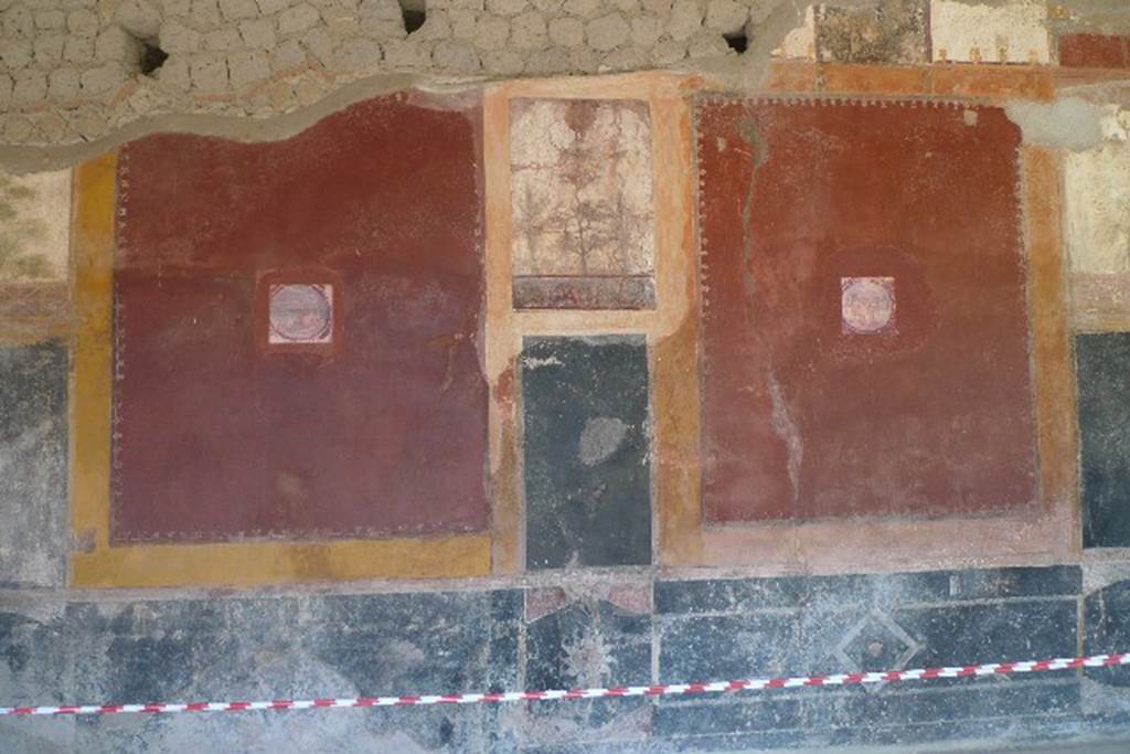 Castellammare di Stabia, Villa San Marco, July 2010. Room 20, east wall.
As part of the improvements to the villa, photo reproductions of some of the frescoes have been added in the wall. The reproduction fresco (centre) has a head of Medusa (upper) a tree and a Nile scene (lower) with two people lifting water with a shadouf, a man with a lance and shield attacking a crocodile. This replaces one now in Naples Archaeological Museum, inventory number 8510. The reproduction medallion of a maritime scene (left) replaces one now in Naples Archaeological Museum, inventory number 9409A. The reproduction medallion of a maritime scene (right) replaces one now in Naples Archaeological Museum, inventory number 9409C. Photo courtesy of Michael Binns.

