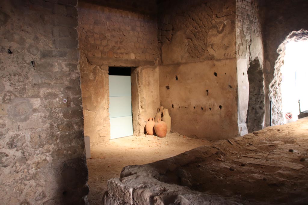 Villa San Marco, Stabiae, October 2022. 
Room 26, looking south-west across bench/hearth towards two adjacent holes made by the Bourbon excavators while tunnelling.
Photo courtesy of Klaus Heese.
