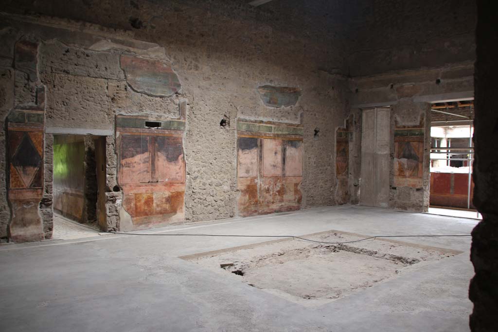 Villa of Mysteries, Pompeii. April 2014. Room 64, looking towards north wall of atrium and north-east corner. 
The doorway to corridor F2 can be seen on the left, on the right is the doorway to the peristyle. 
Photo courtesy of Klaus Heese.
